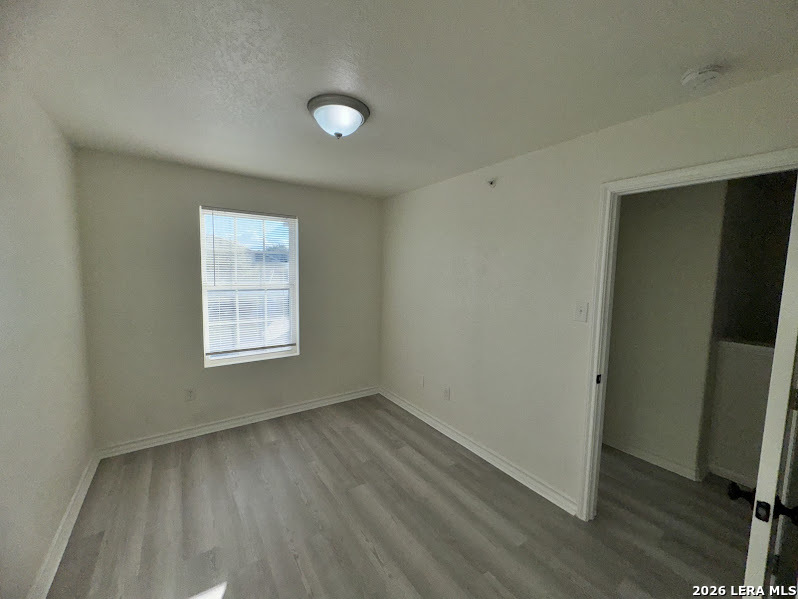 16808 Dancing Ava, Unit 2 Selma, TX 78154 - Photo 12 of 15 an empty room with wooden floor and windows