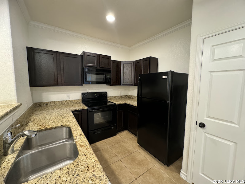 16808 Dancing Ava, Unit 2 Selma, TX 78154 - Photo 6 of 15 a kitchen with granite countertop stainless steel appliances and a refrigerator