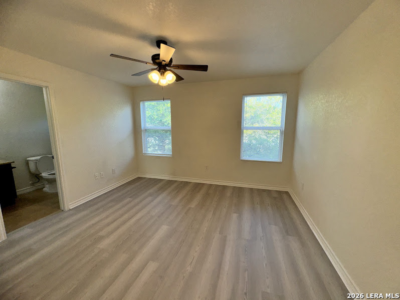 16808 Dancing Ava, Unit 2 Selma, TX 78154 - Photo 9 of 15 wooden floor in an empty room with a window