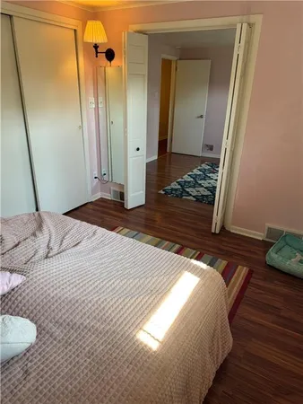 a bedroom with a bed and a mirror