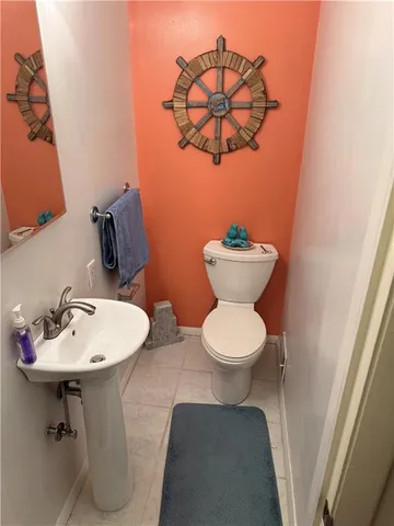 a bathroom with a sink toilet and a mirror