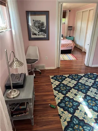 a bedroom with furniture and a mirror