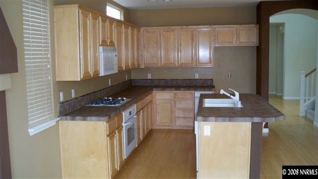10535 Meeks Bay Court Reno, NV 89521 - Photo 2 of 9 a kitchen with a stove and a refrigerator