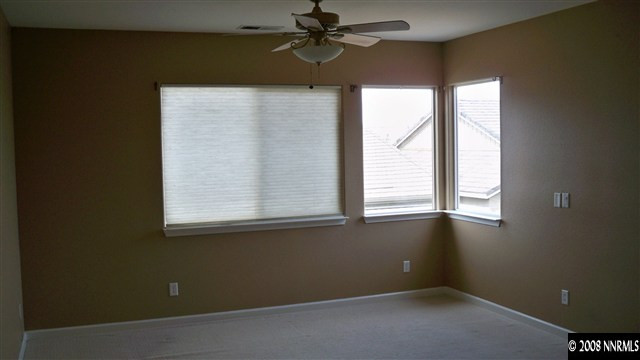 10535 Meeks Bay Court Reno, NV 89521 - Photo 7 of 9 an empty room with a window and a fan