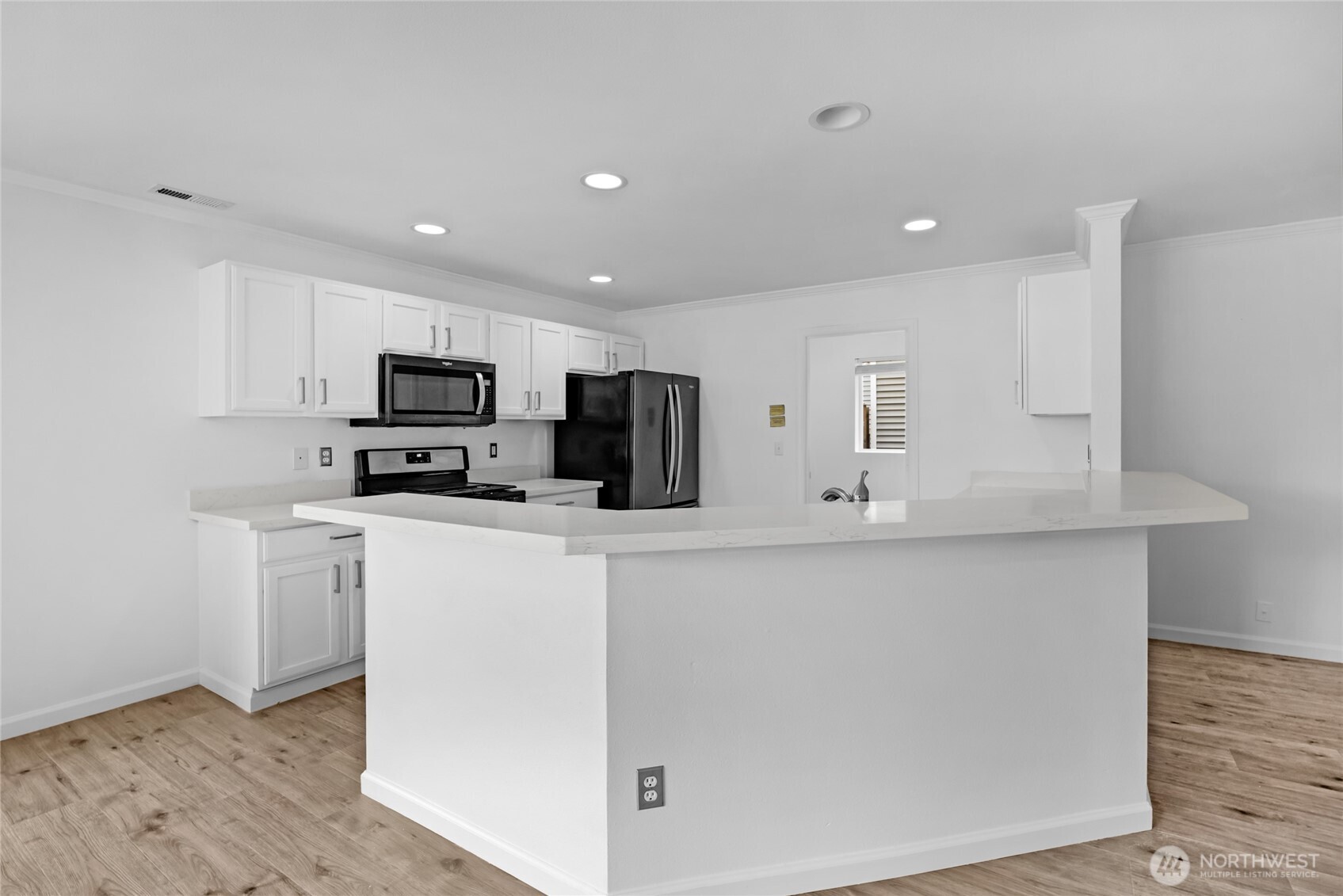 3903 154th Place Southeast Bothell, WA 98012 - Photo 3 of 30 a kitchen with stainless steel appliances a stove a sink a refrigerator a microwave and cabinets