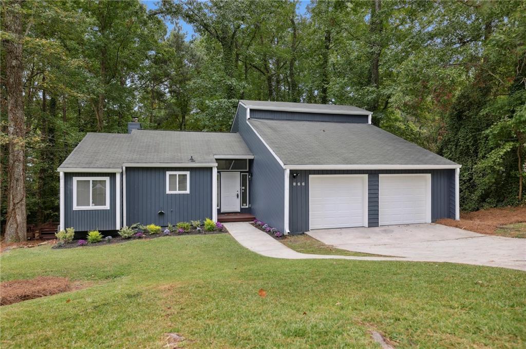 a view of a house with yard and tree s