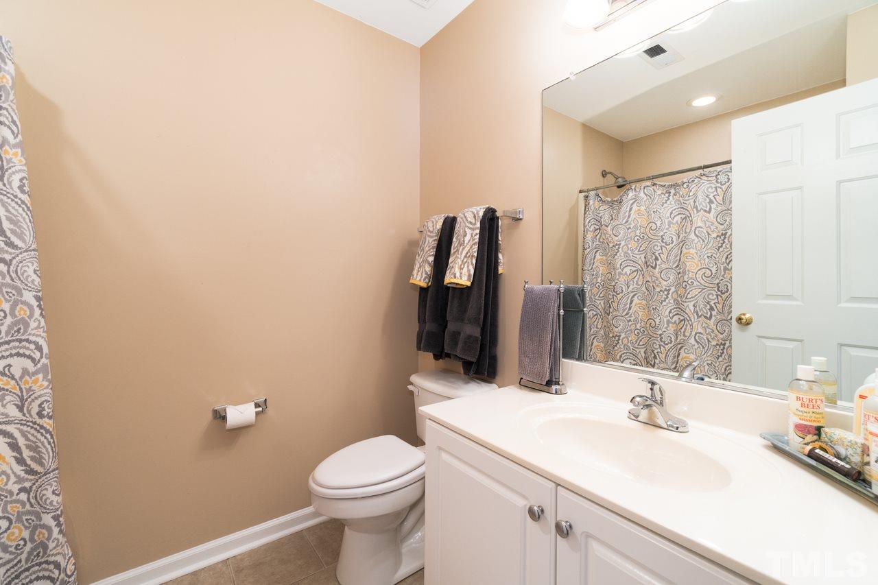 8727 Harps Mill Road Raleigh, NC 27615 - Photo 19 of 25 a bathroom with a sink a toilet and shower