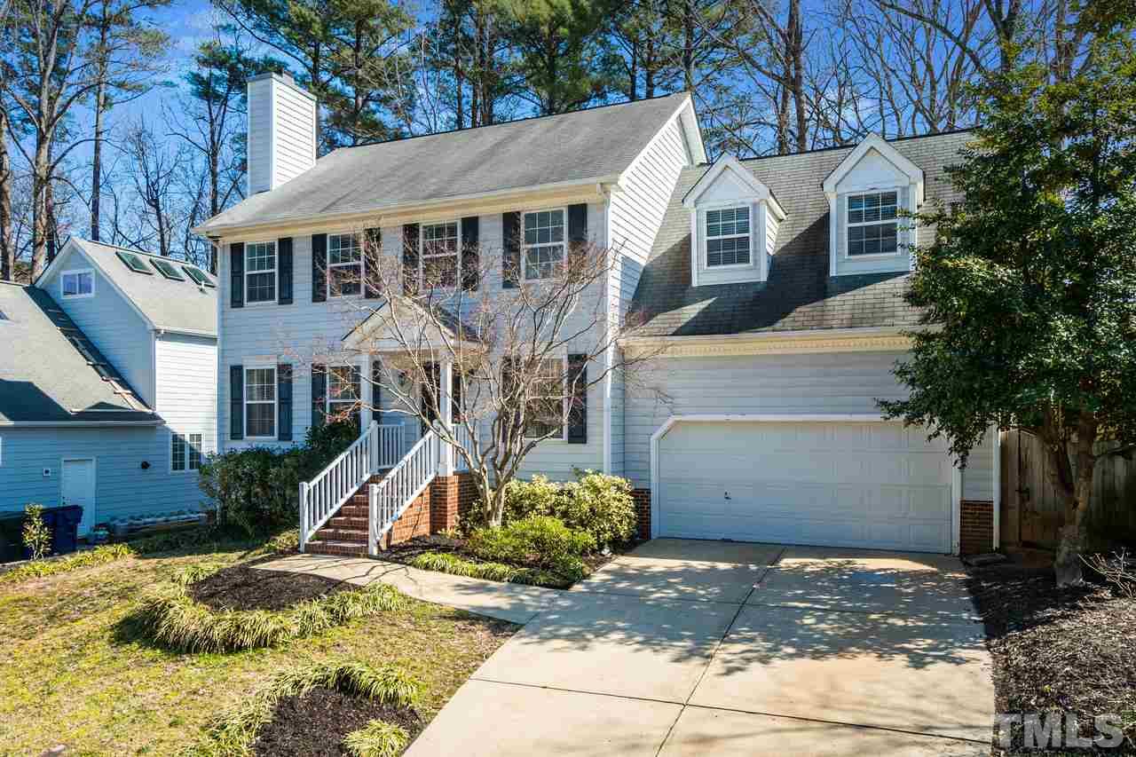 8727 Harps Mill Road Raleigh, NC 27615 - Photo 3 of 25 a view of a white house with a large tree and wooden fence