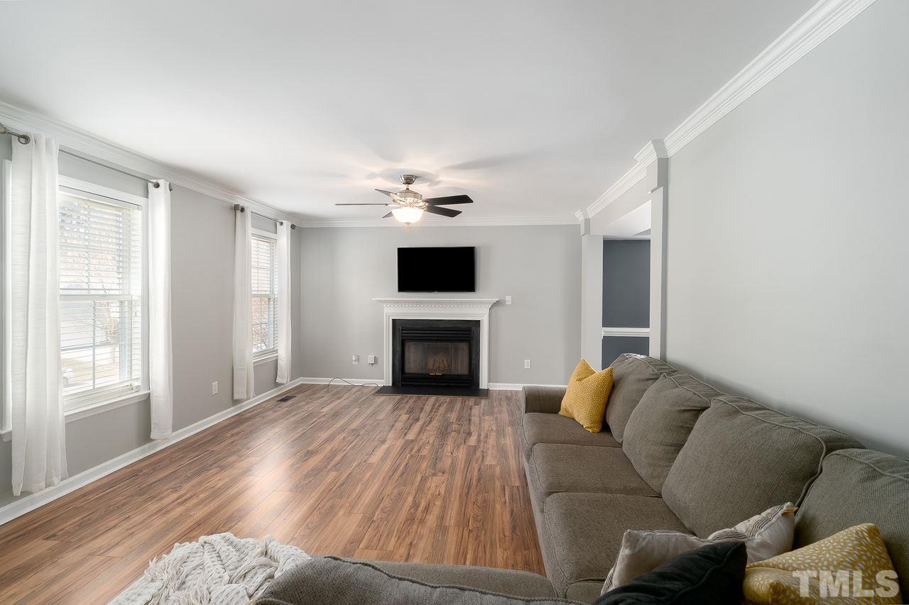 8727 Harps Mill Road Raleigh, NC 27615 - Photo 6 of 25 a living room with furniture and a fireplace