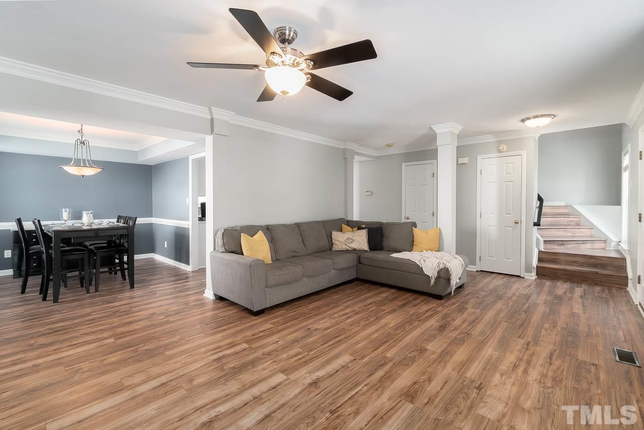 8727 Harps Mill Road Raleigh, NC 27615 - Photo 25 of 25 a living room with furniture and a wooden floor