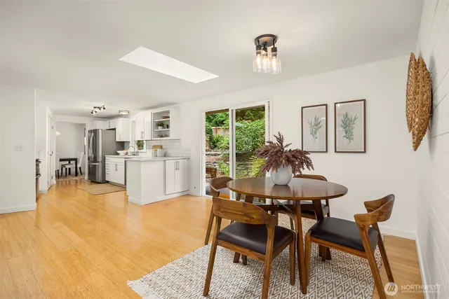 a living room with furniture dining table and a large window