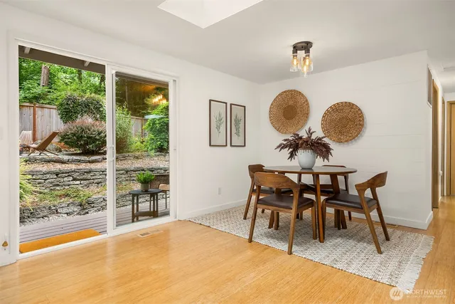a dining room with furniture and a window