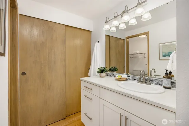 a bathroom with a double vanity sink and a mirror