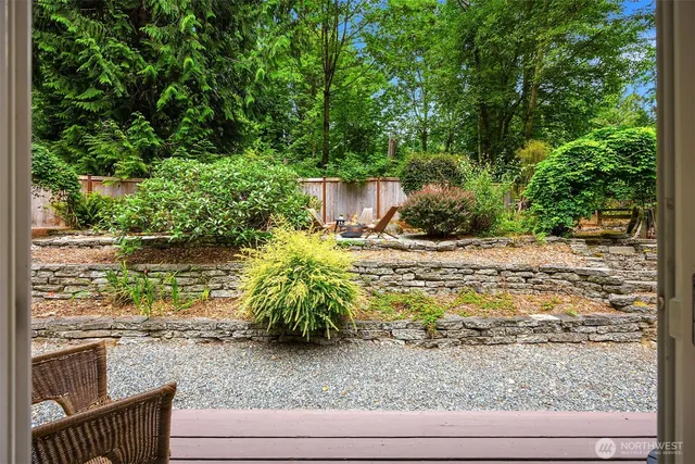 a backyard of a house with a yard and outdoor seating