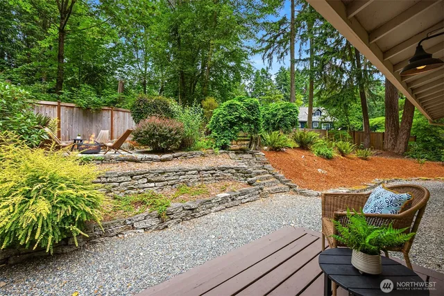 a view of a backyard with sitting area