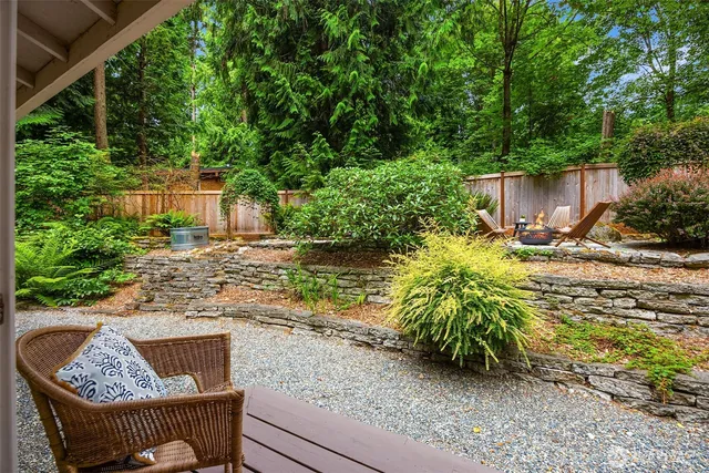 a view of backyard with outdoor seating and green space