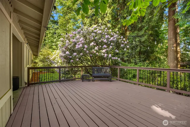 a view of a balcony with wooden floor and fence