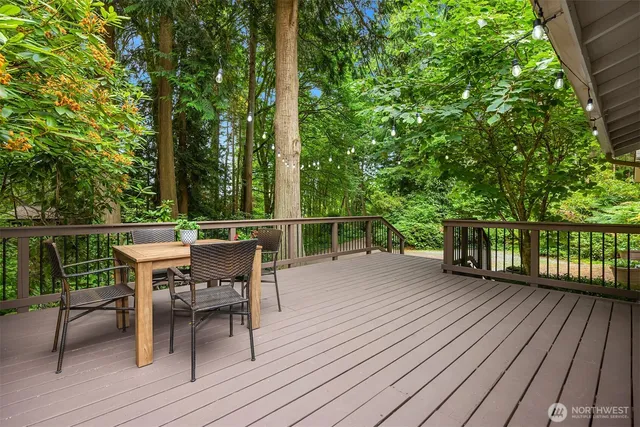 a view of a deck with wooden floor and outdoor seating