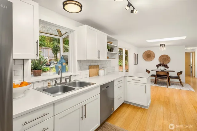 a kitchen with stainless steel appliances granite countertop a sink and cabinets