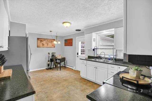 a kitchen with granite countertop sink cabinets and living room