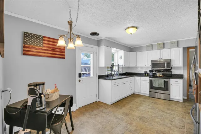 a kitchen with cabinets a sink and appliances