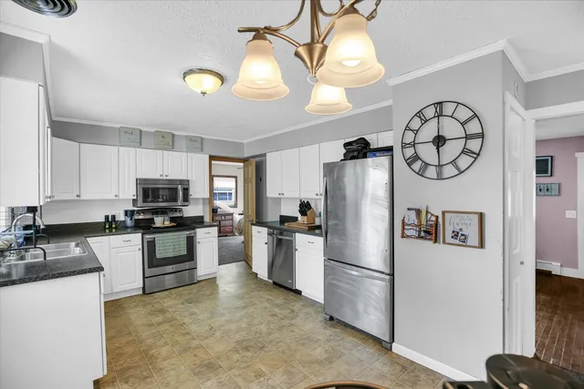 a kitchen with refrigerator a microwave a stove and cabinets