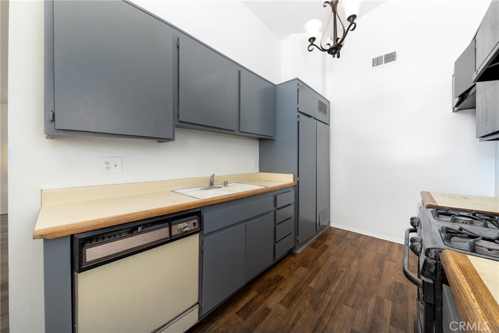 1800 East Old Ranch Road, Unit 134 Colton, CA 92324 - Photo 11 of 22 a kitchen with sink cabinets and wooden floor