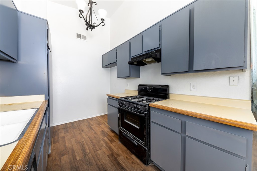 1800 East Old Ranch Road, Unit 134 Colton, CA 92324 - Photo 12 of 22 a kitchen with stainless steel appliances granite countertop a sink a stove and cabinets