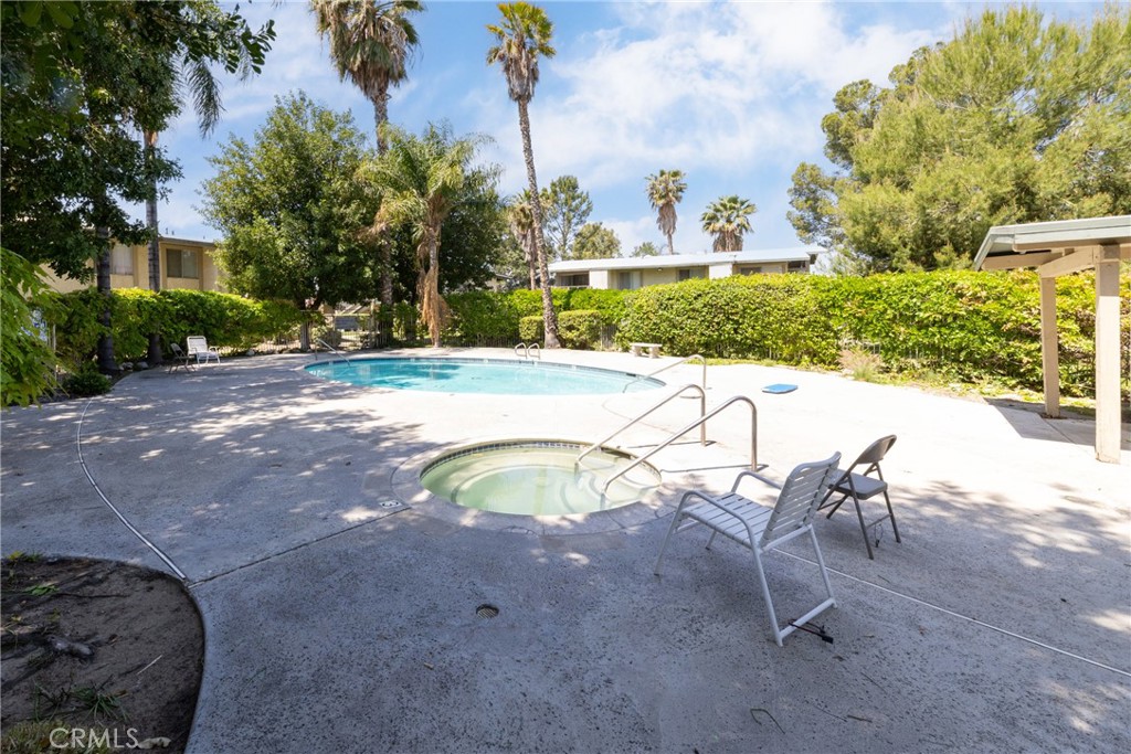 1800 East Old Ranch Road, Unit 134 Colton, CA 92324 - Photo 20 of 22 a view of a swimming pool with a yard and plants