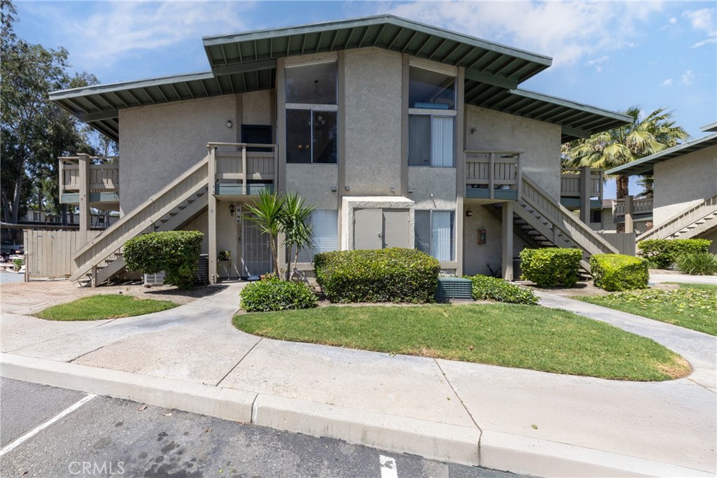 1800 East Old Ranch Road, Unit 134 Colton, CA 92324 - Photo 3 of 22 a front view of a house with a yard