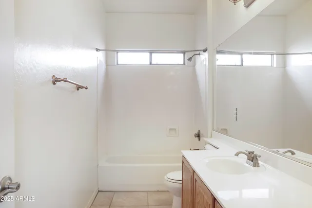 a bathroom with a bathtub shower sink vanity and a toilet