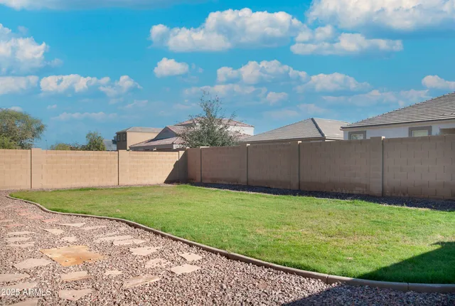 a front view of a house with a garden and yard