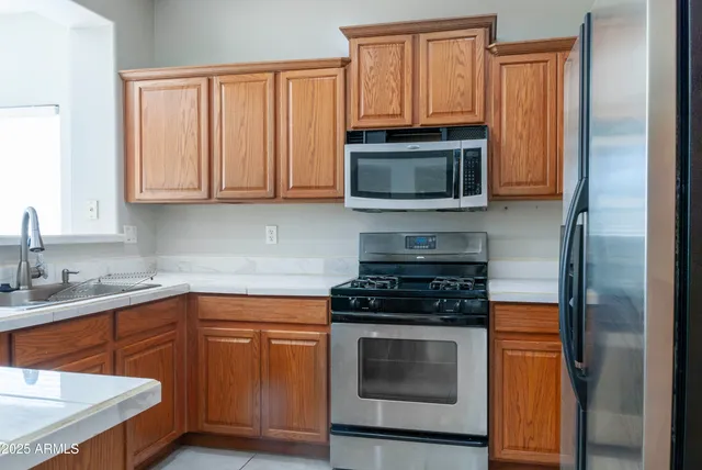 a kitchen with a sink stove and microwave