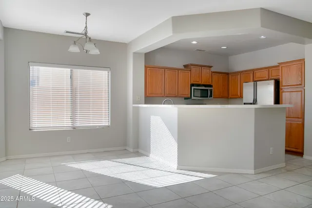 a kitchen with stainless steel appliances granite countertop a refrigerator sink and microwave