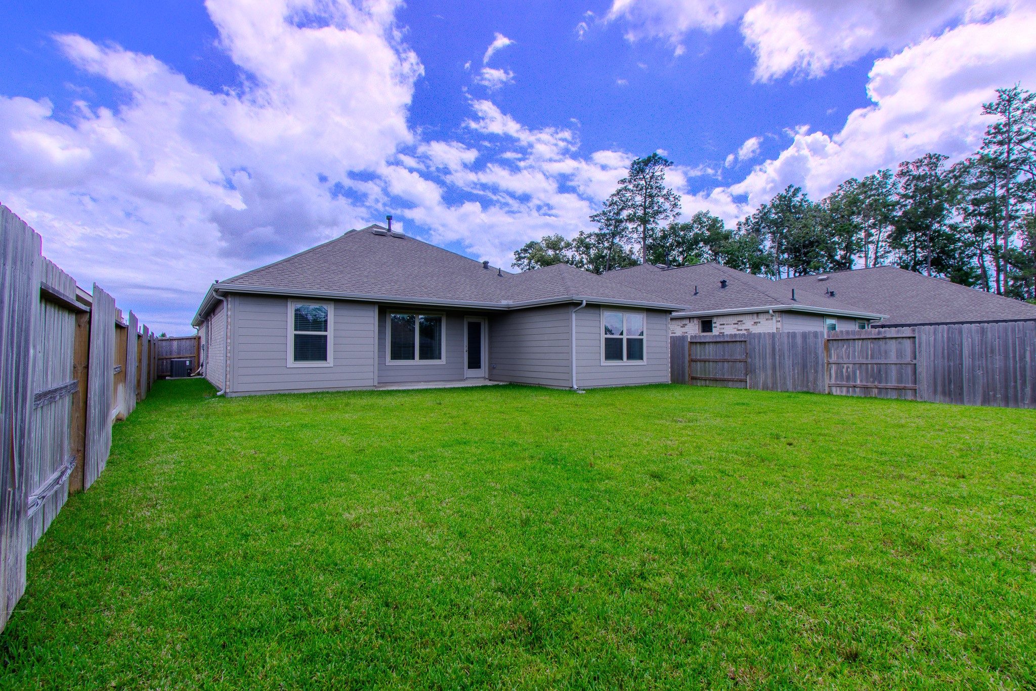 3113 Catalonion Court Conroe, TX 77301 - Photo 30 of 45 a view of a house with a big yard