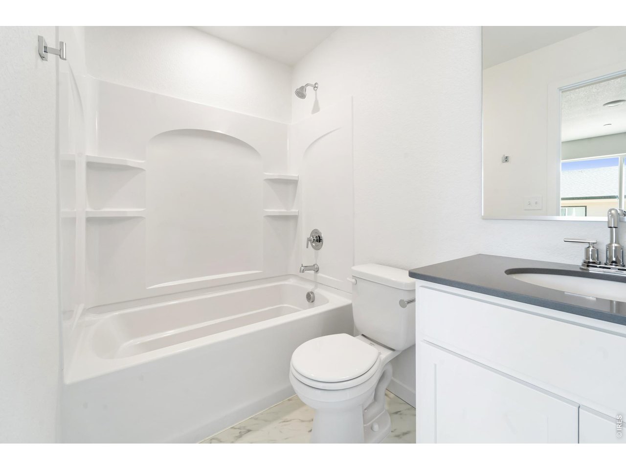 3913 Net Street Evans, CO 80620 - Photo 12 of 19 a bathroom with a granite countertop toilet a sink and bathtub
