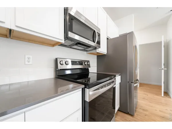 a kitchen with stainless steel appliances kitchen island a stove and a microwave