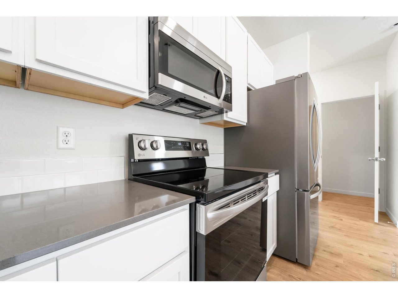 3913 Net Street Evans, CO 80620 - Photo 4 of 19 a kitchen with stainless steel appliances kitchen island a stove and a microwave