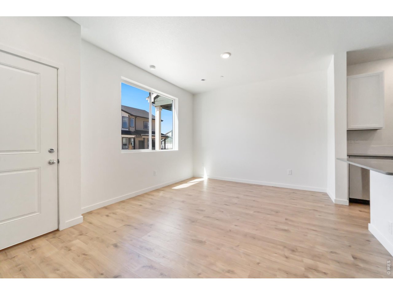 3913 Net Street Evans, CO 80620 - Photo 5 of 19 a view of an empty room with a window and wooden floor