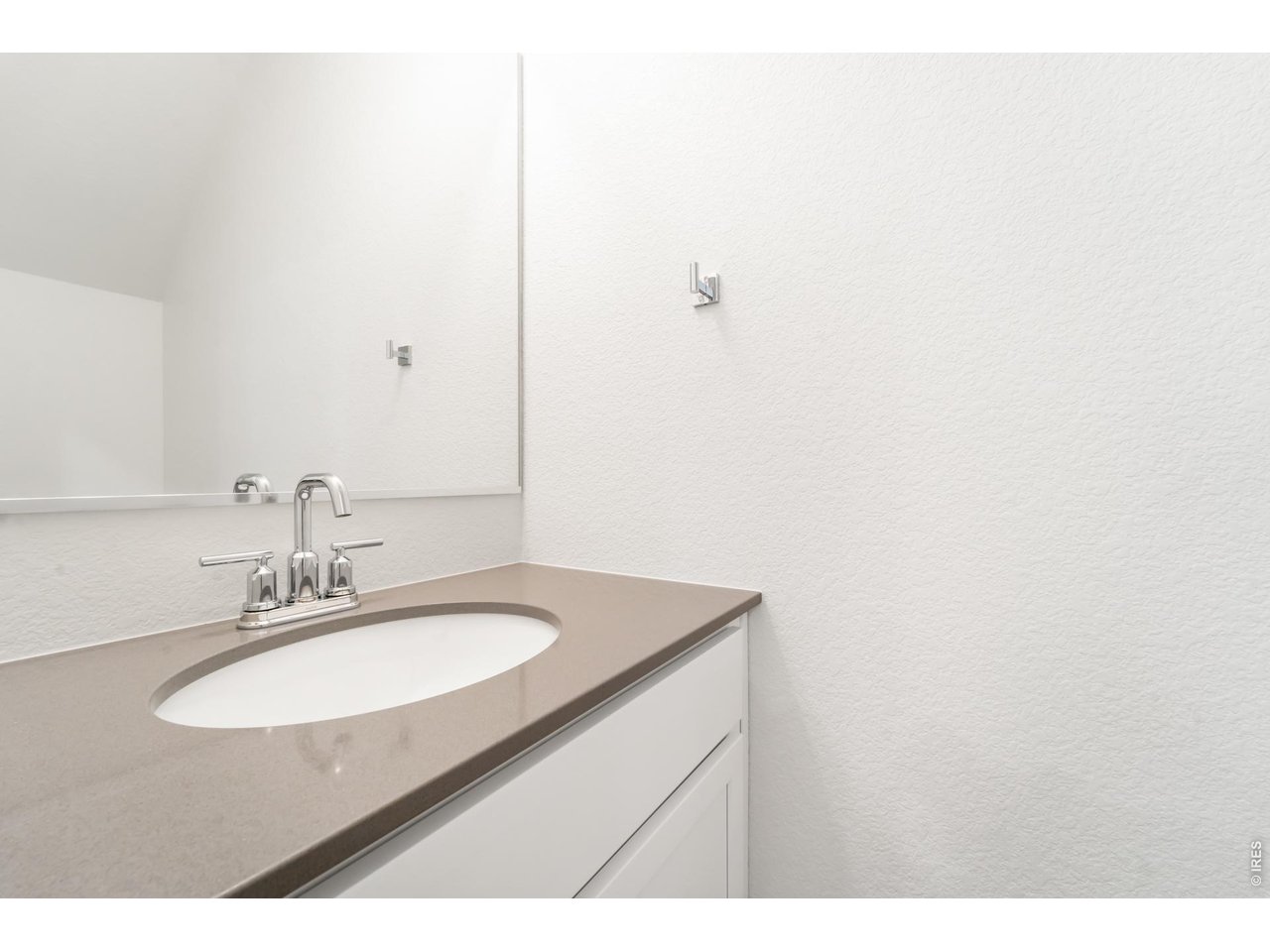 3913 Net Street Evans, CO 80620 - Photo 7 of 19 a bathroom with a sink and a mirror