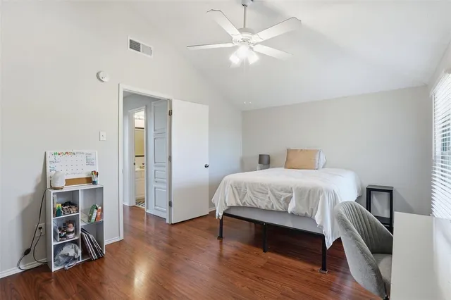 a spacious bedroom with a bed and a chair