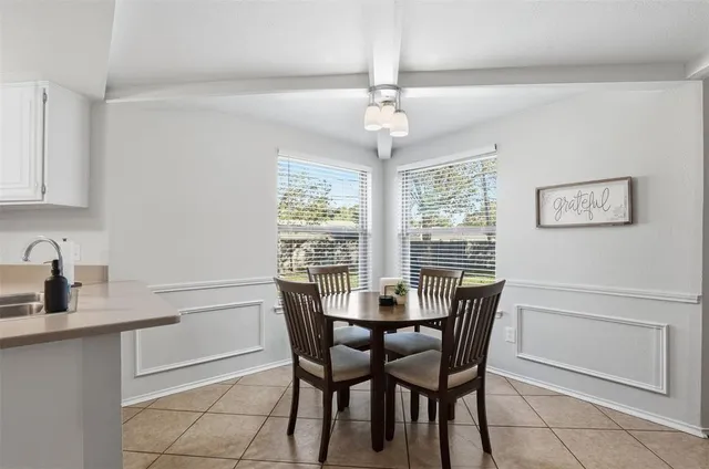 a view of a dining room with furniture and a chandelier