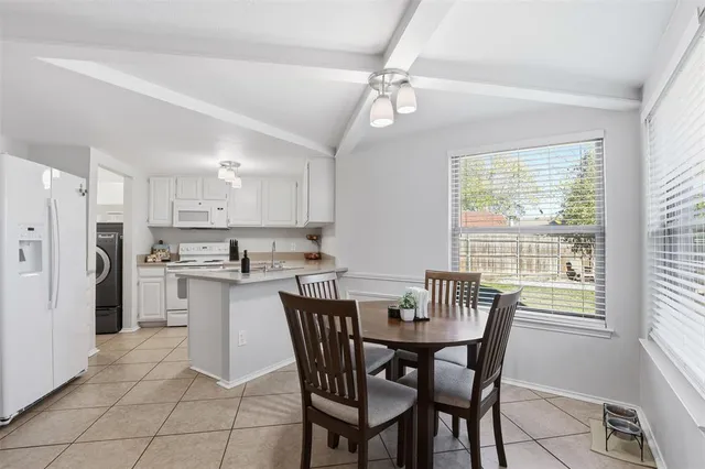 a view of a dining room with furniture and a chandelier