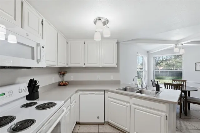 a kitchen with a sink a stove and cabinets