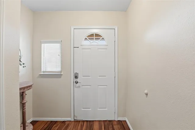 a view of a hallway with front door