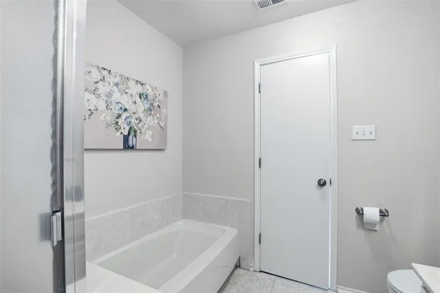 a white bath tub with a shower