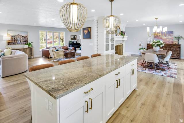 1350 Canyon Park Road Bountiful, UT 84010 - Photo 16 of 38 Spacious open-concept living area featuring an expansive kitchen island with a stone countertop, recessed lighting, and wood-finish flooring