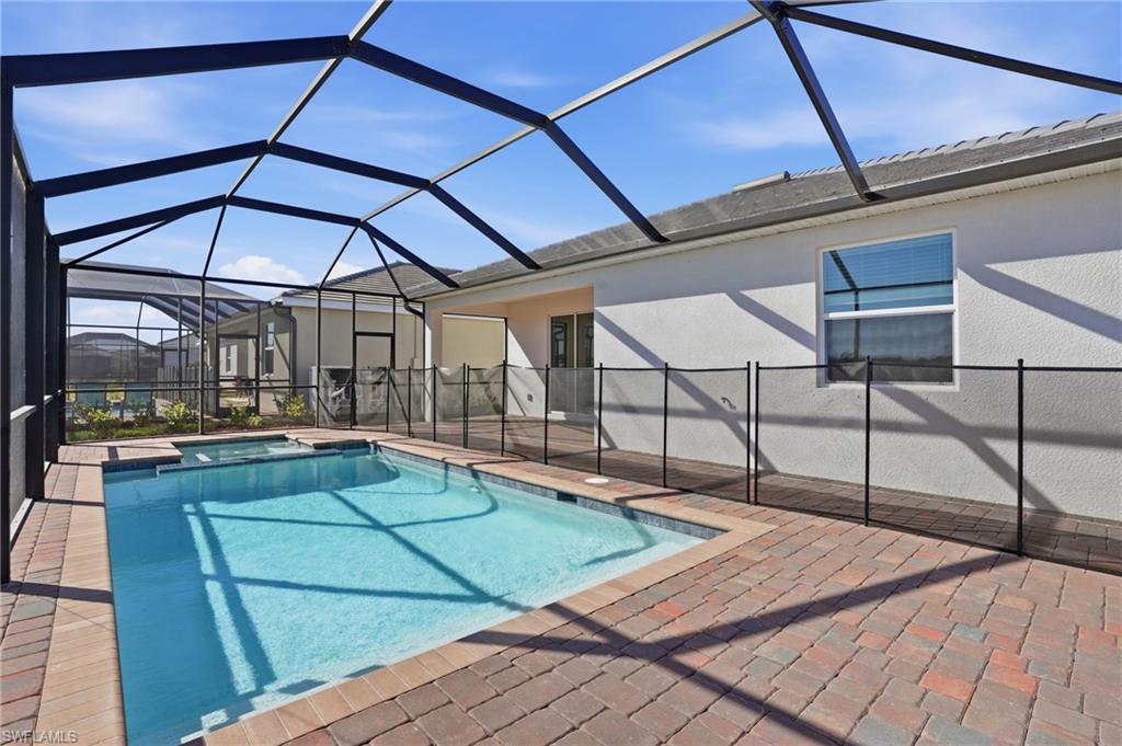 3958 Button Sage Road Alva, FL 33920 - Photo 35 of 50 Relaxing pool / spa with a sunroom, a lanai, and a patio
