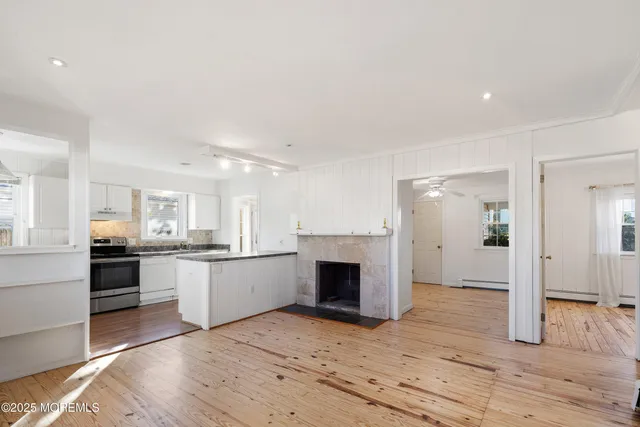 a large kitchen with kitchen island a sink stainless steel appliances and cabinets