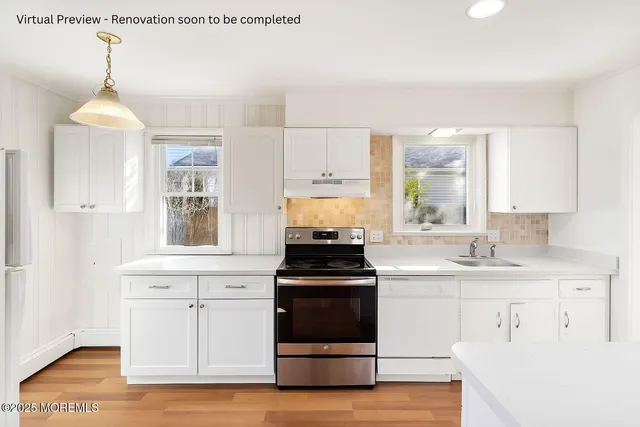 a kitchen with a stove and a white cabinets